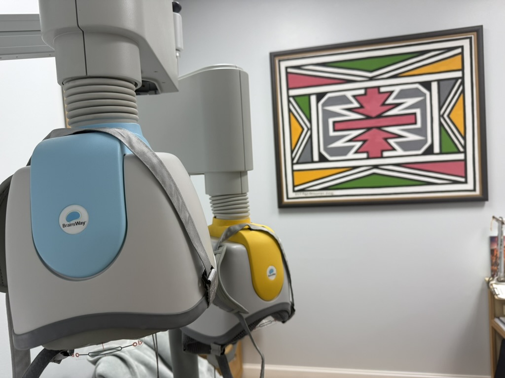 Blue and yellow BrainsWay Deep TMS helmets in the Institute for Advanced Psychiatry office.